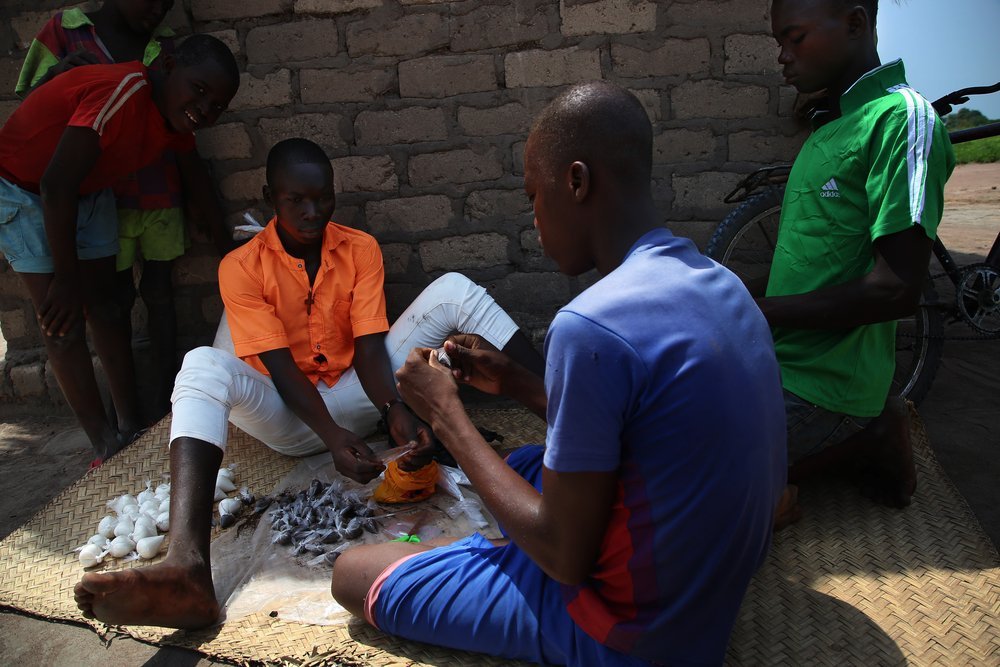 Teenagers prepare small teabags for sale at site B for displaced people in Kabo, a town in northern Central African Republic.