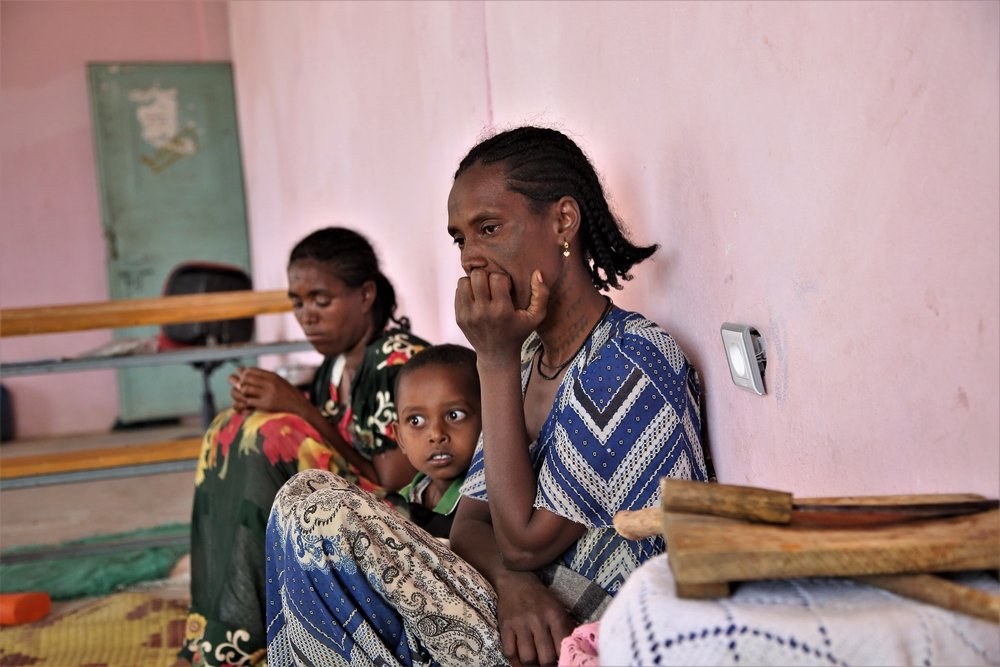 Wagiha, from Humera, sits with her children at the preparatory school in Abi Adi, a town in central Tigray.