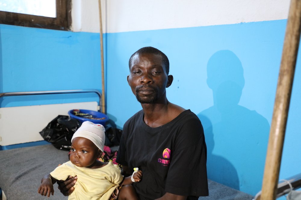 Chadrac Mbaya with his daughter La Joie, one-year-old, at the Popokabaka General Referral Hospital. La Joie was admitted to Popokabaka hospital four days ago with symptoms of typhoid. 