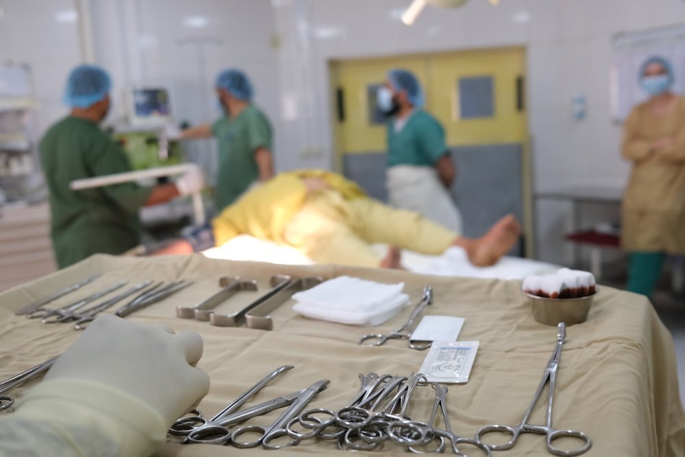 MSF and Ministry of Public Health medical staff prepare to perform surgery to remove a kidney stone from Esa, 63, Boost hospital, Lashkar Gah, Helmand Province, Afghanistan