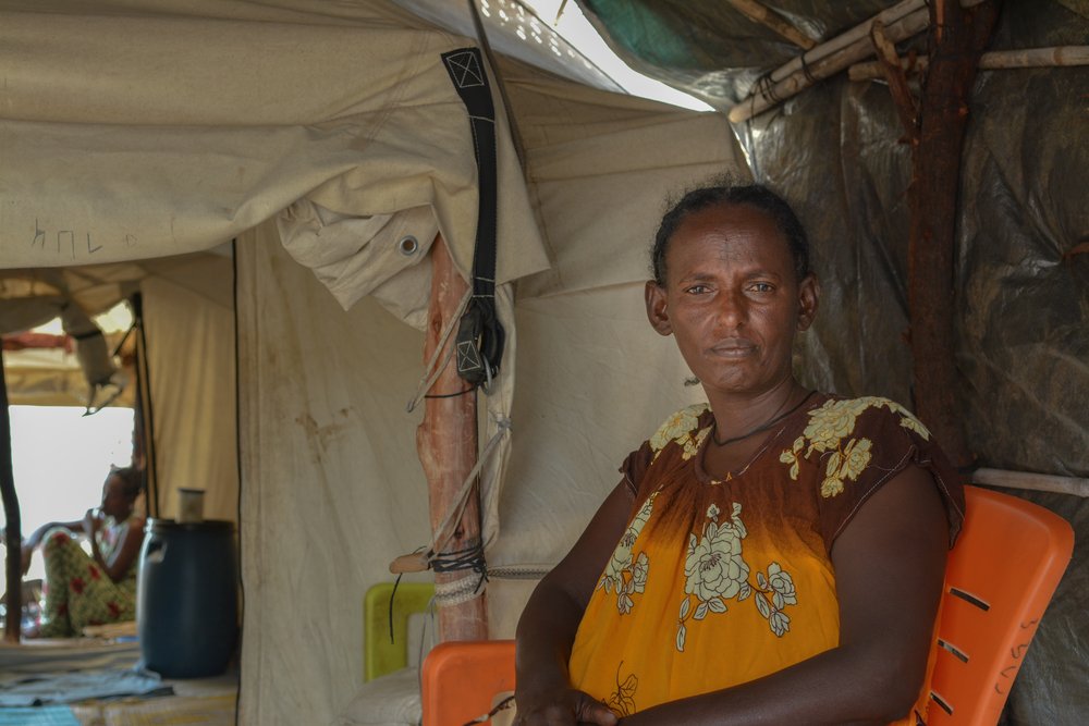 Mihret Gereyginer sits in her tent in Umm Rakouba camp, Eastern Sudan. “It’s bad in the camps, because even the weather makes everything complicated. Our tent has been destroyed many times by the rain and wind...&quot;