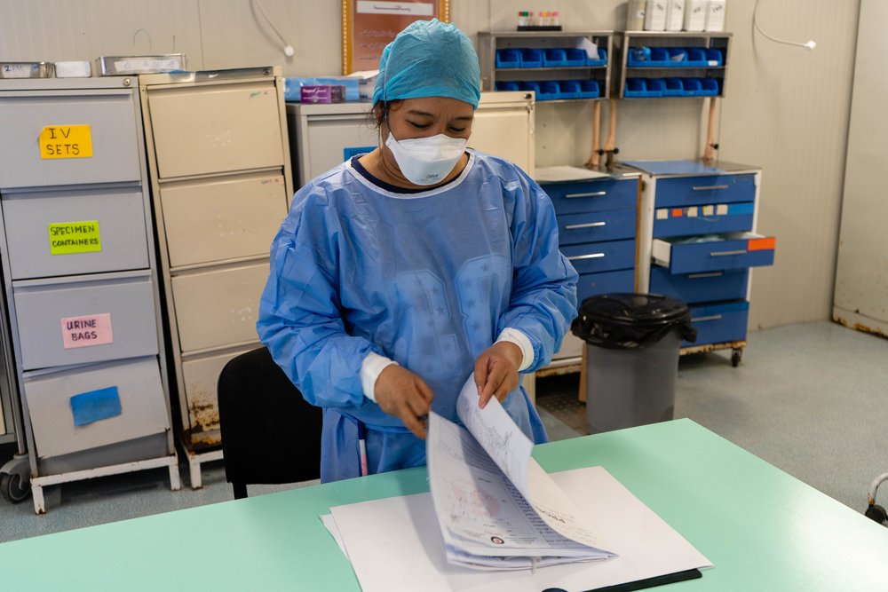 MSF Nurse Theresa Sanchez checking on patient data in Abu Sitta Hospital, where MSF is running its activities. (March, 2022).
