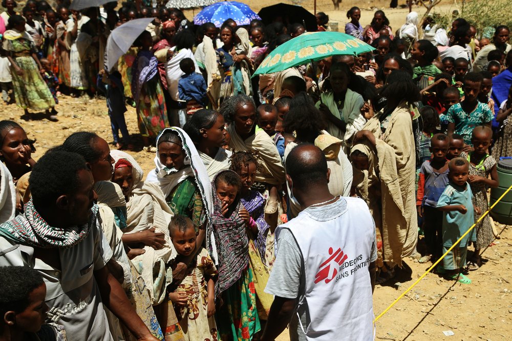 MSF translator Tedros asks people to line up to wait for medical consultations at a mobile clinic in the village of Adiftaw, in the northern Ethiopian region of Tigray.