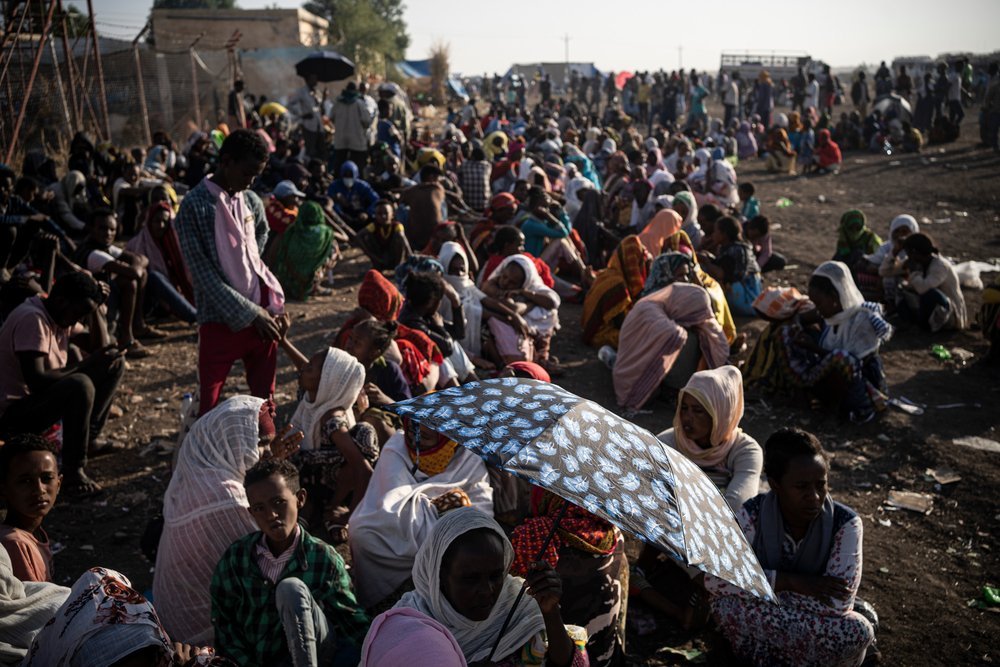 Hamdayet crossing point, Sudan, early morning. November 2020. This crowd walked miles from neighbouring Ethiopia to reach Sudan to escape the conflict in their region. 