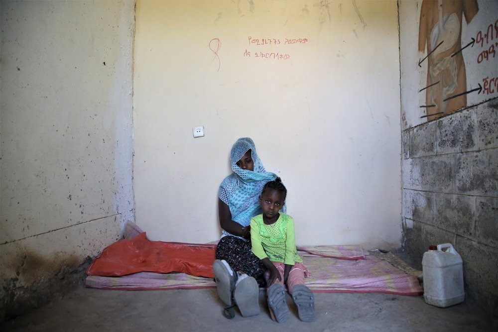 Leterbrhan lies with her five-year-old daughter in a small room where around 20 people sleep at the elementary school in Abi Adi, a town in central Tigray. 