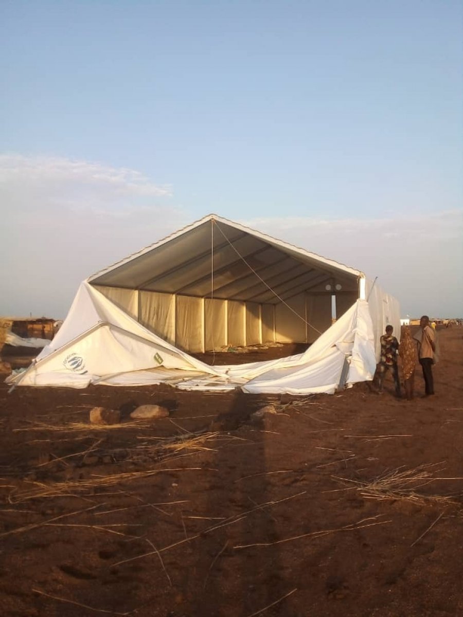 A UNHCR rubhall damaged by the wind in the camp.