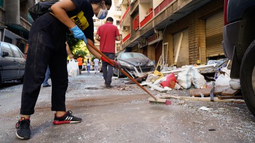 A young volunteer helping in cleaning up debris and shuttered glass from the streets of Achrafieh neighborhood of Beirut. 