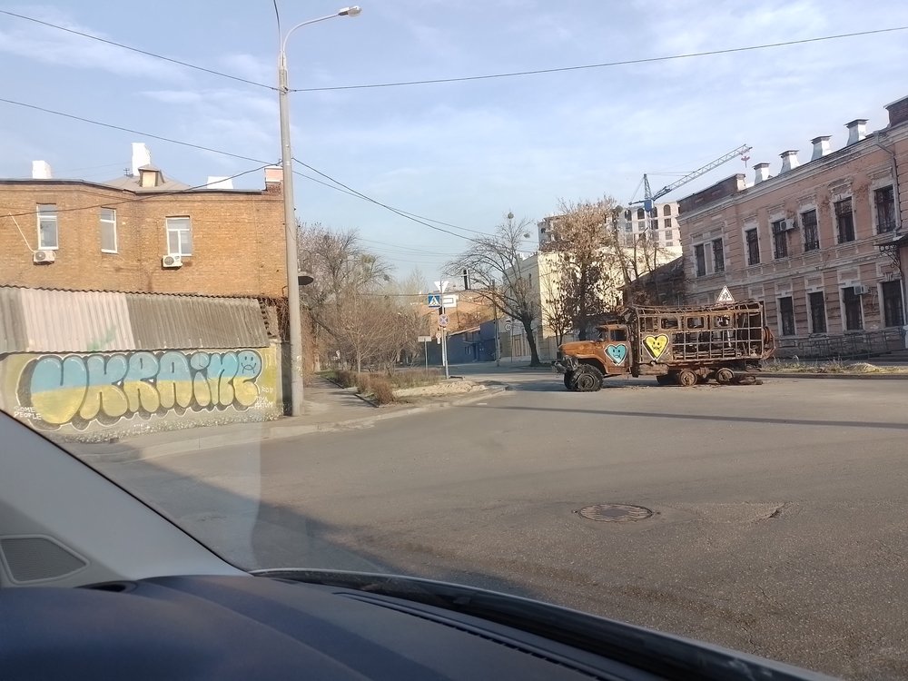 Hopeful graffiti in the colours of the Ukrainian flag on a destroyed military vehicle on the streets of Kharkiv. (April. 2022).
