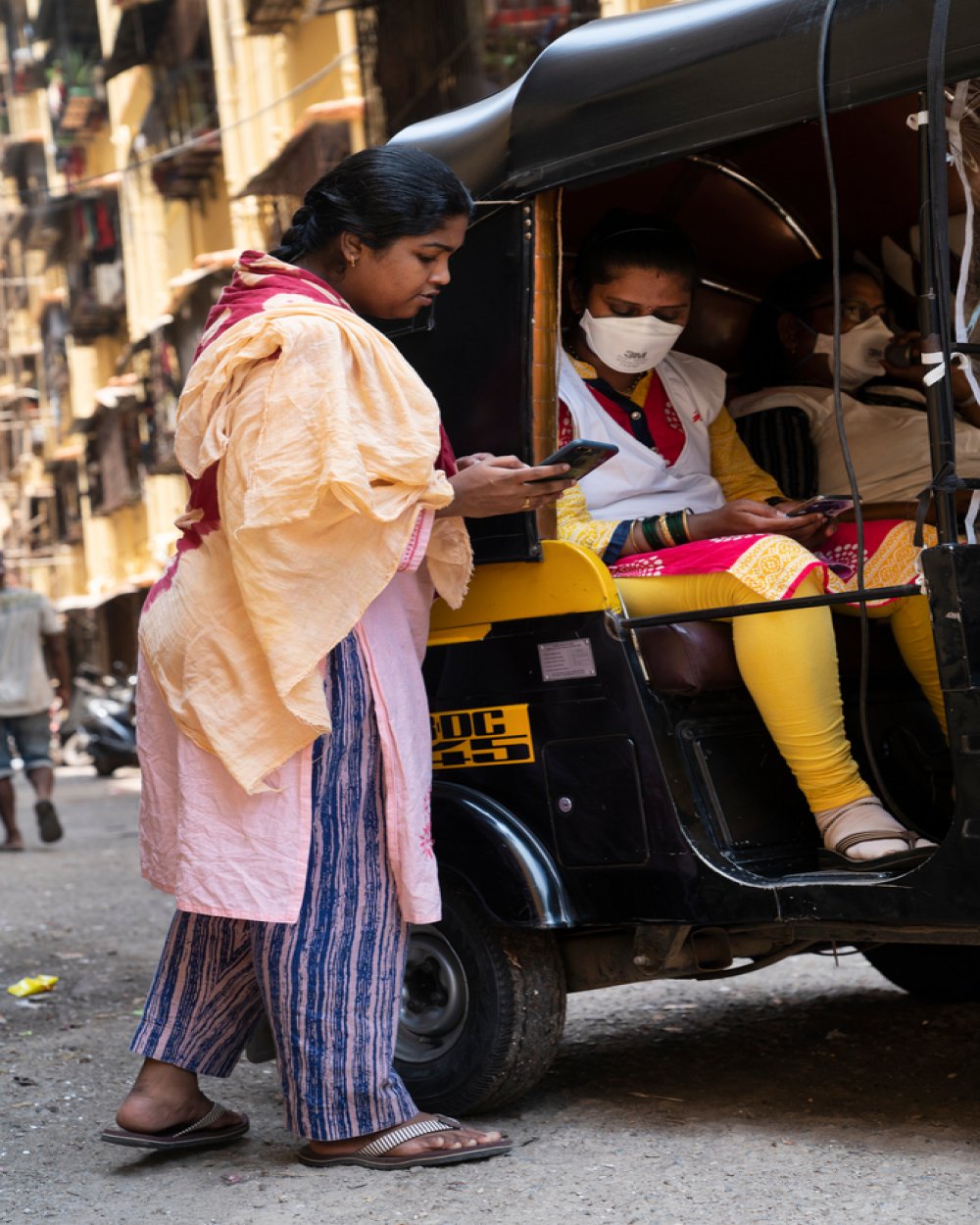 A female resident of slum rehabilitation colony in M-East Ward, Mumbai interacting with Health Educators during Awareness campaign. One of the main issue the health educators emphasis is the  consistent use and management of masks.