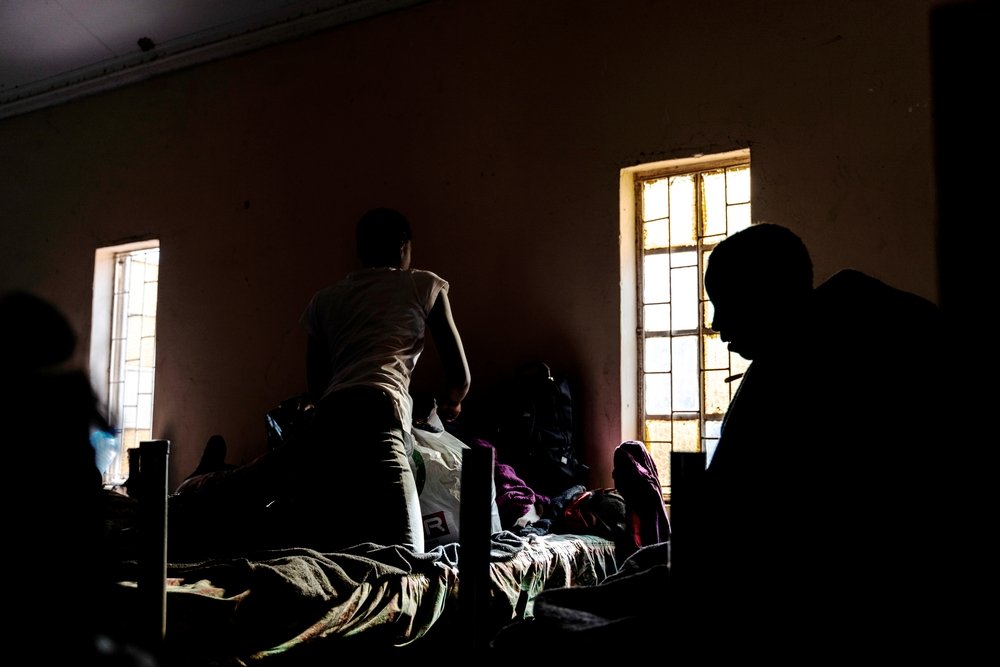 Women sit on their beds at a centre for female refugees located in Musina, South Africa.