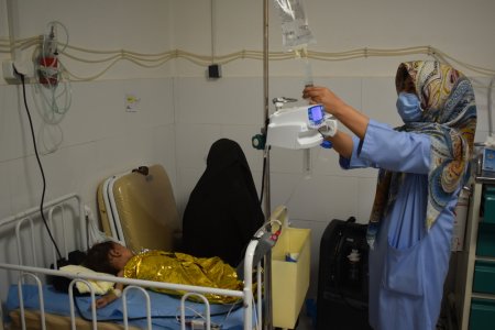 MSF nurse Fatima, pictured giving IV fluid to a malnourished child in the ICU room of the ITFC, Herat regional hospital.