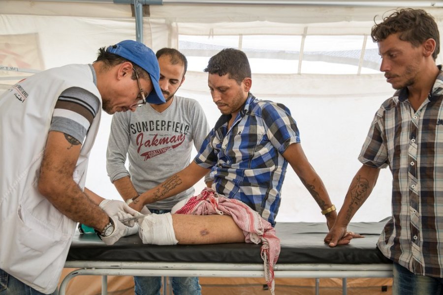 2017: Ain Issa camp, Syria. MSF physiotherapist Michaël treats Ahmad. While fleeing Raqqa, Ahmad stepped on an explosive device planted by fighters from the Islamic State group. His injuries were so severe that both his legs had to be amputated. 