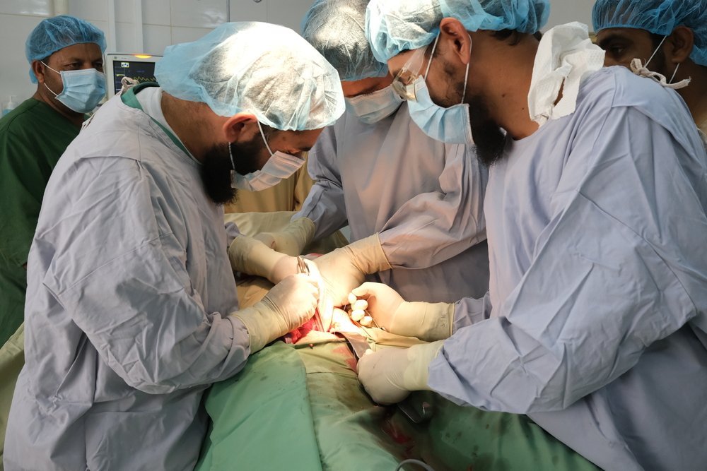 MSF and Ministry of Public Health staff perform surgery in one of three operating theatres at Boost hospital, Lashkar Gah, Helmand Province, Afghanistan. In 2020 teams performed over 4,900 surgical interventions.