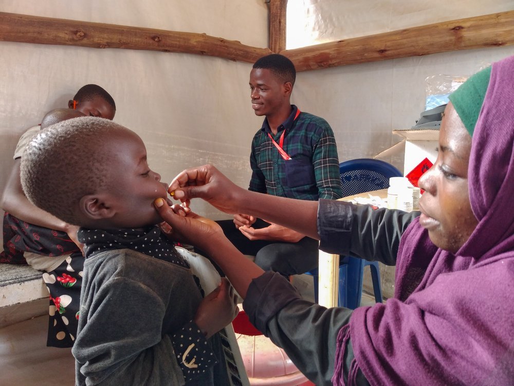 During a mass campaign, MSF nurse administers oral vaccine to a Burundian child in the primary health care facility at Nduta camp.