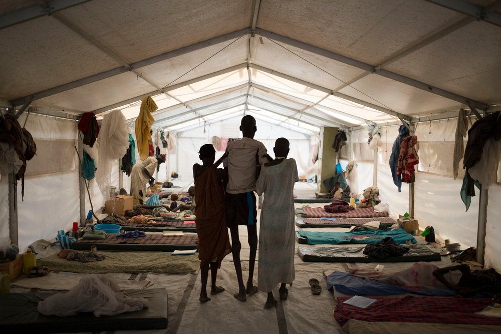 Kala azar sufferer Ruai Puot Malow (56 years) is assisted by his wife Yakuony Jock Deng (right) and a relative at a Médecins Sans Frontières / Doctors Without Borders hospital in Lankien, South Sudan, Tuesday, 13 Jan 2015. 
