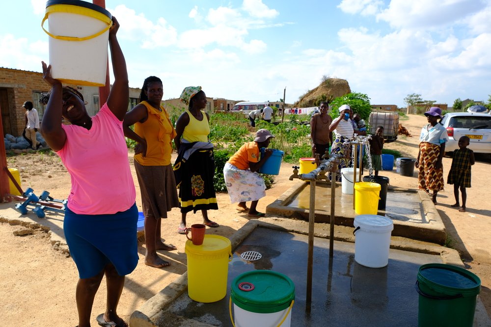 Women fetching water at a water point in the informal settlement of Stoneridge in Southern Harare.