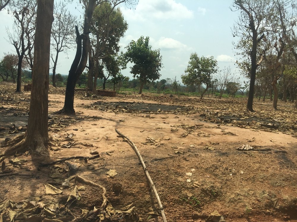Buildings stand in ruins at Elevage, a makeshift camp set up in 2013 on the outskirts of Bambari town, which hosted 8,500 displaced people until it was set on fire and destroyed in early June. 15 June 2021.