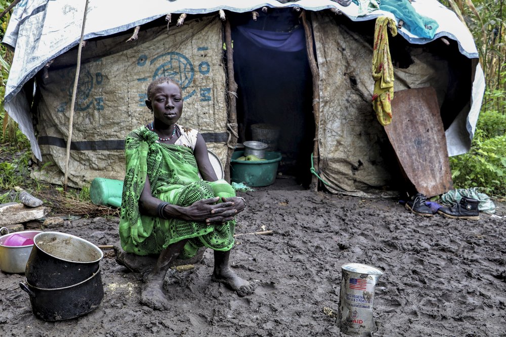  A young woman sitting in front of her shelter in Lukurunyang after heavy rainfall destroyed her crops.