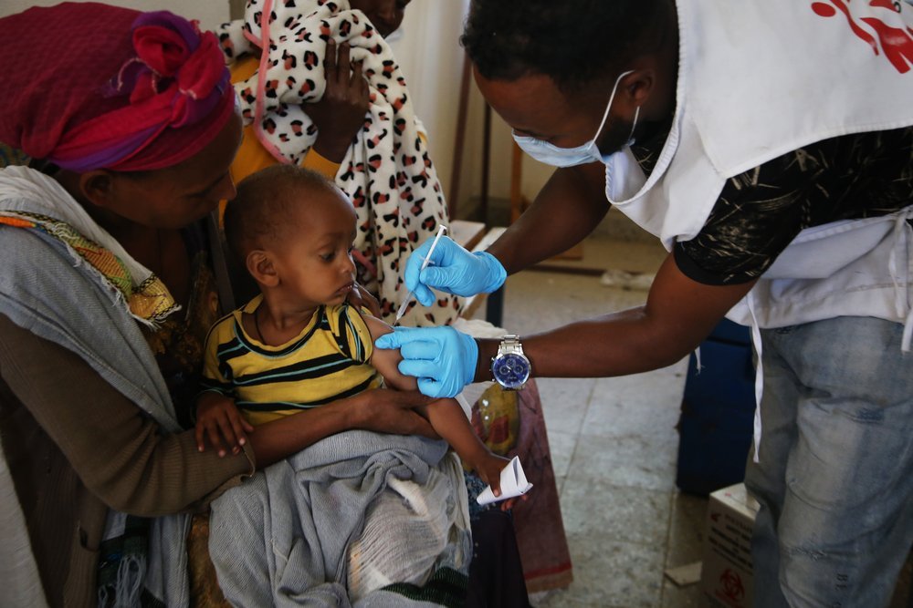 An MSF staff member vaccinates a child during a mobile clinic at the health centre in Sebeya, a town close to the Eritrean border in the northern Ethiopian region of Tigray.