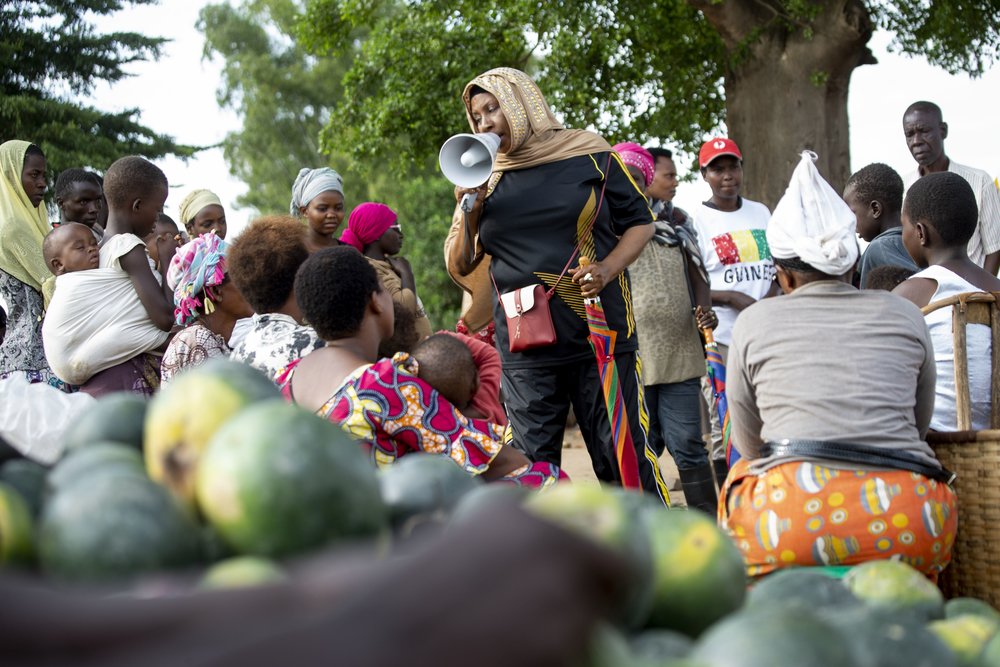 A community health worker with a megaphone raises awareness about cholera in Bujumbura’s Buterere market. 