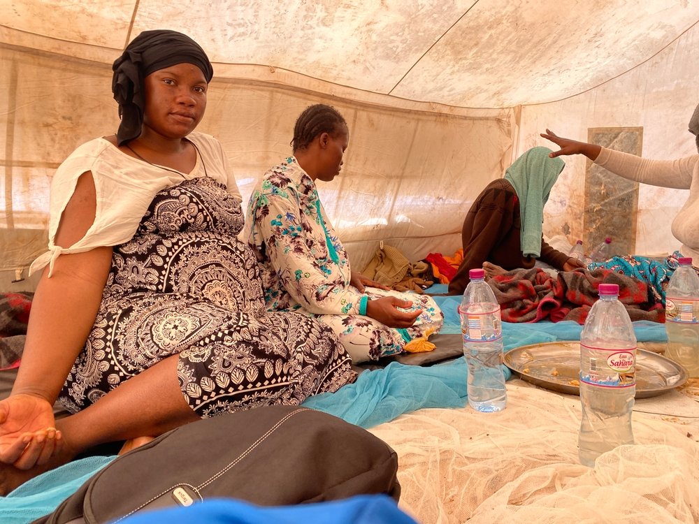 Safi Keita finishes eating lunch in a tent set up for pregnant women and their families in Assamaka. Safi has two children and is four months pregnant with her third.