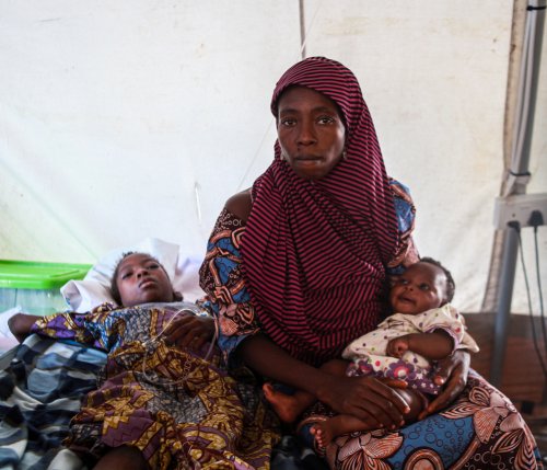 Yagana waits for her daughter, Bawagana (left) to receive a blood transfusion as part of her malaria treatment. 