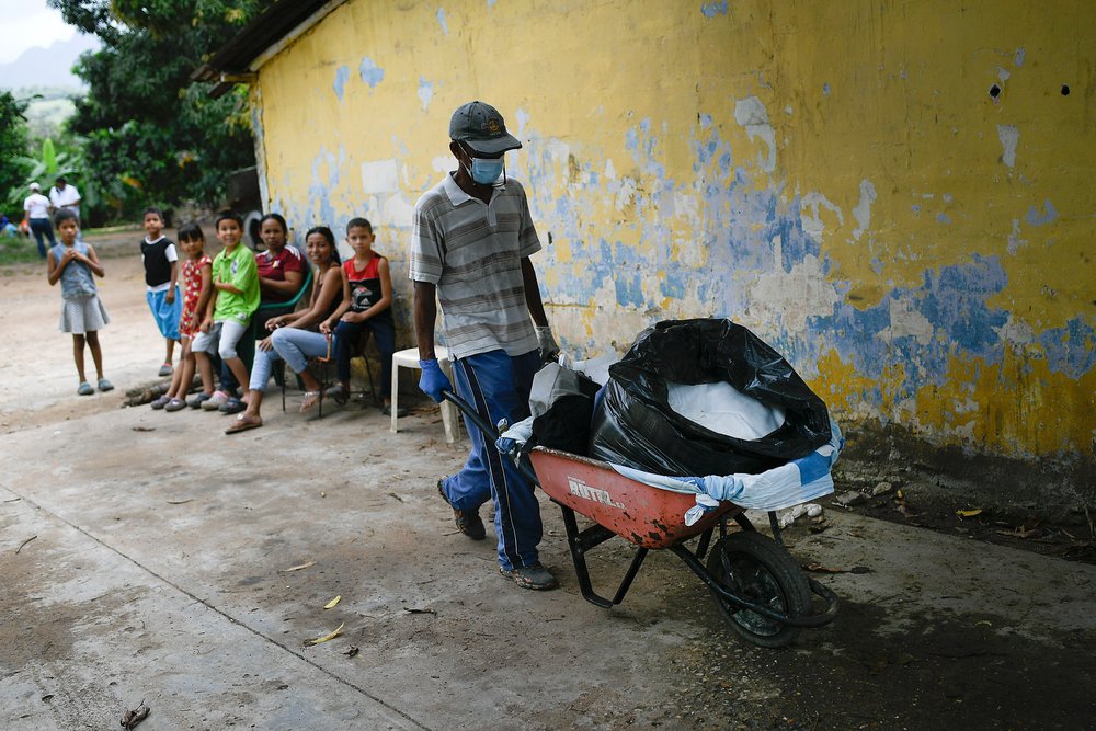Cruz Tovar (57) works as a metal worker in Desparramadero community. Today he has come with his wheelbarrow to help transport medical supplies for use at the health fair.