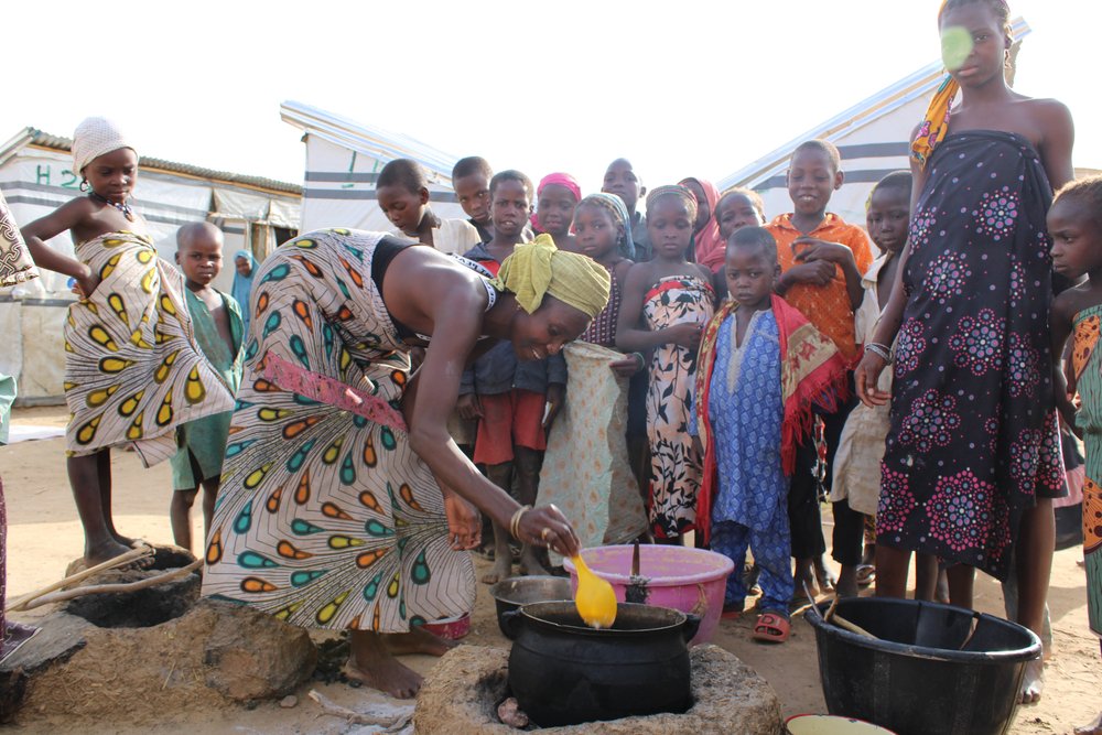 “I make this dough of crushed beans and fry it and sell it. It is a staple for people living in the camp”, says Saratu, who lives in Emir Palace camp, with children gathered around her waiting for a portion of the fried dough.