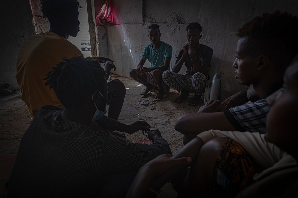 A group of migrants and refugees gathered together in a shared dwelling in Gargaresh, Libya. (August 2021).