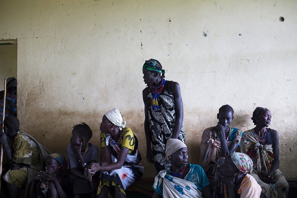 Women wait in the waiting room of the MSF clinic in Gumuruk, Jonglei state, South Sudan. The MSF clinic saw almost entirely women and children arriving for treatment, while men appear to be hiding in the bush.