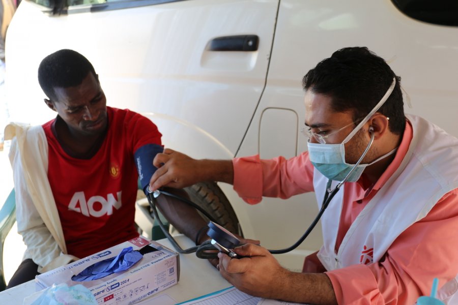 Dr. Abdukareem Saleh patient Abas Muhammad  in the mobile clinic in the Hygiene Fund camp, a camp for African migrants who work as cleaners to clean the city under the contract with the Hygiene Fund.