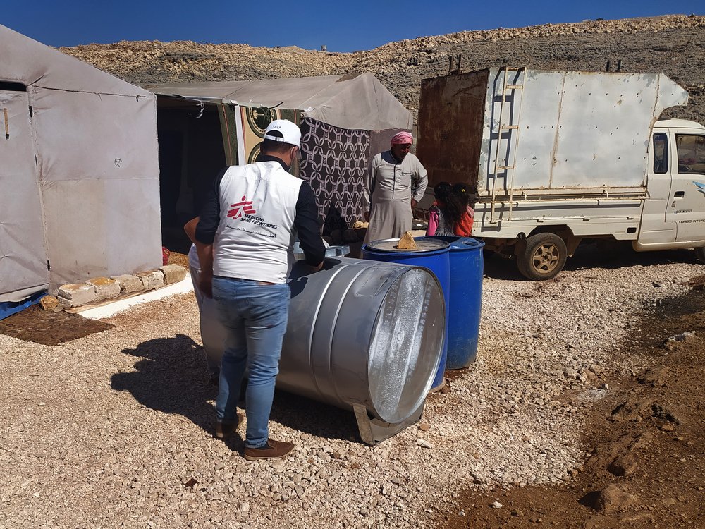 In a camp for internally displaced people in northwest Syria, MSF staff members are supervising a regular water trucking activity to ensure the provision of clean water to the families living in tents.