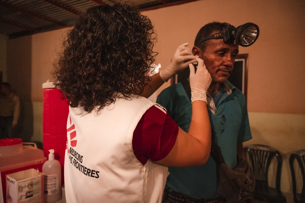 Monserrat Vargas, MSF bioanalyst, takes a blood sample from 53-year-old Omar for a test to determine whether he has malaria. Bolívar, Venezuela, October 2019.