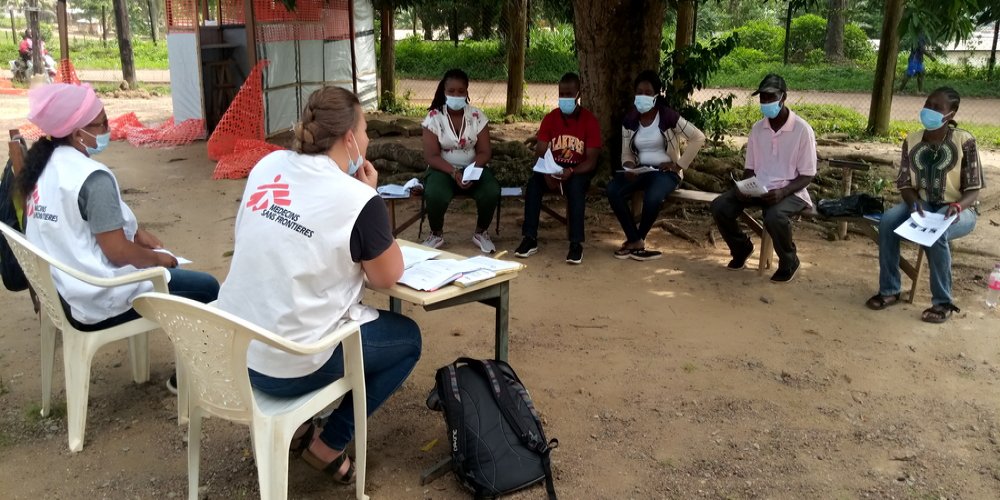 Rita M. Nelson, an MSF infection prevention and control nurse (left), and Laura Wright, an MSF epidemiologist, speak at the Yekepa YMCA clinic in Nimba county, Liberia, as part of an effort to improve preparedness for a potential Ebola outbreak.