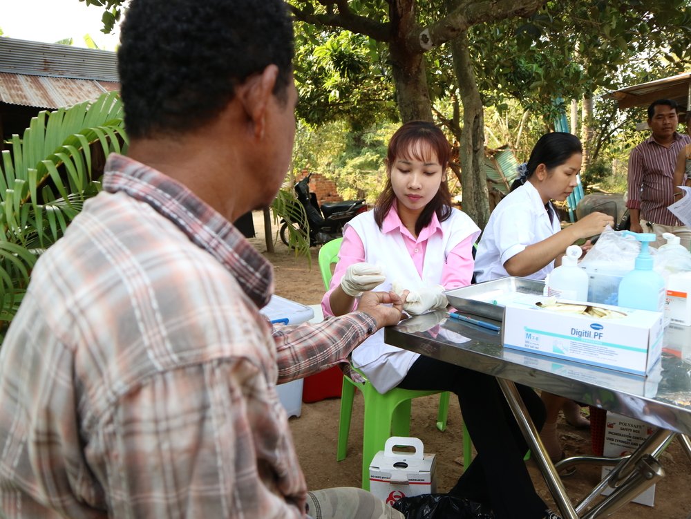 The nurses Prak Vichhuta and Ty Chhunnly test blood samples of villagers for Hepatitis C during an active case finding campaign in a village in Moung Ruessei district in Cambodia. 2019.