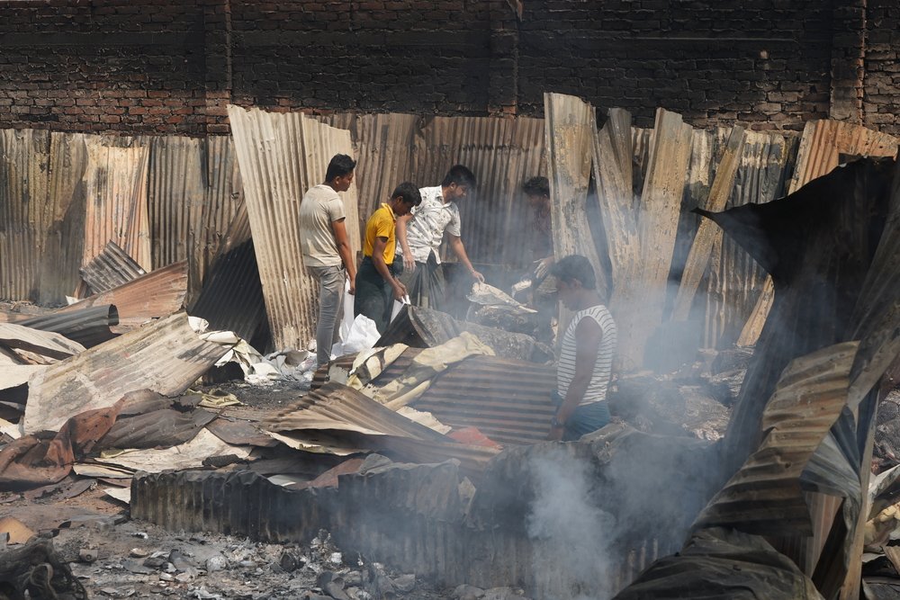 The morning after the fire destroyed thousands of shelters and facilities, people like these men next to MSF’s Balukhali clinic were trying to save what was left of their belongings.