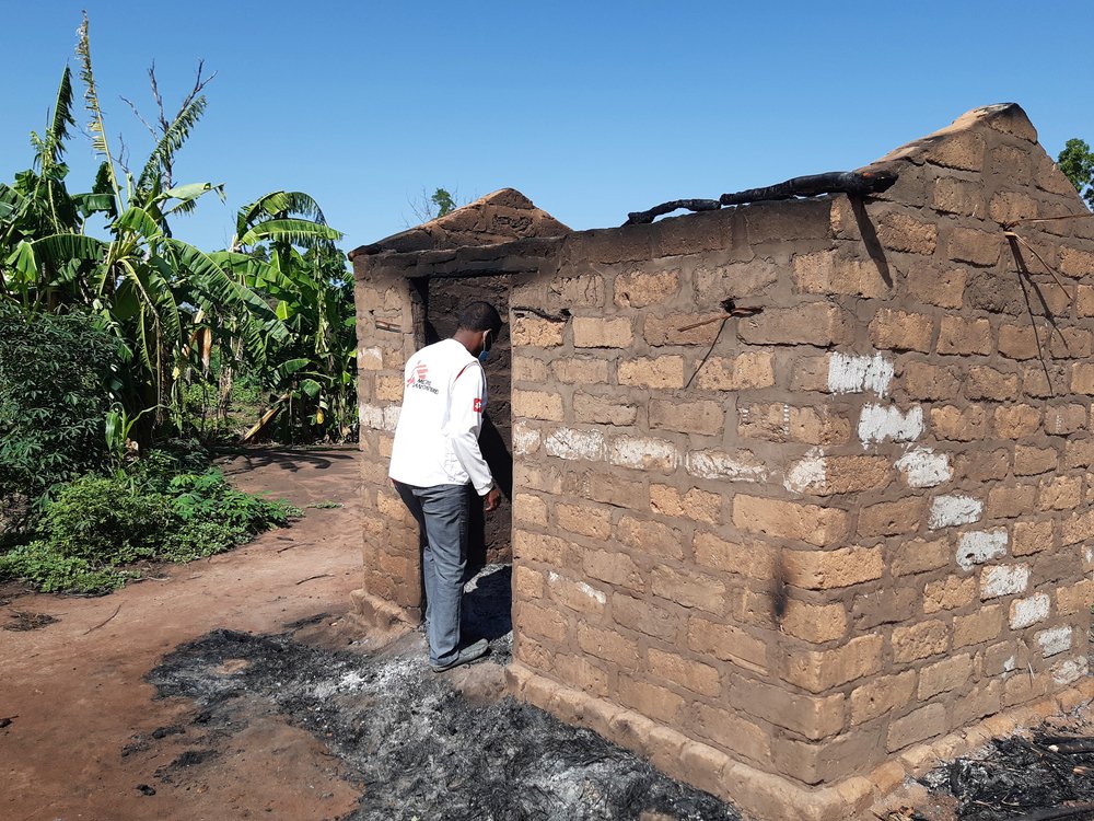 An MSF staff member inspects a burned house in the village of Beltounou, on the outskirts of Kabo town, in northern Central African Republic.