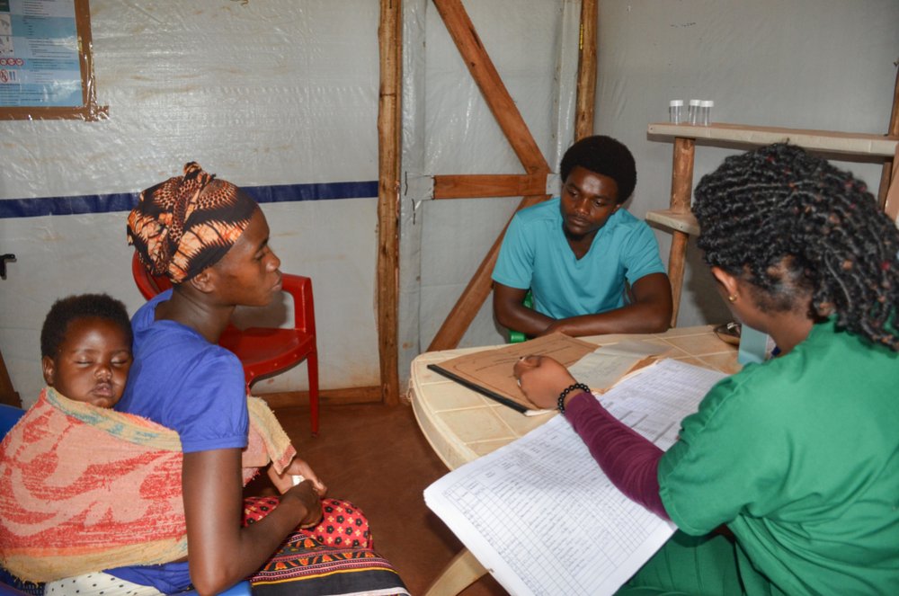 MSF midwife and a medical translator attending a patient at the sexual and reproductive health clinic in Nduta.