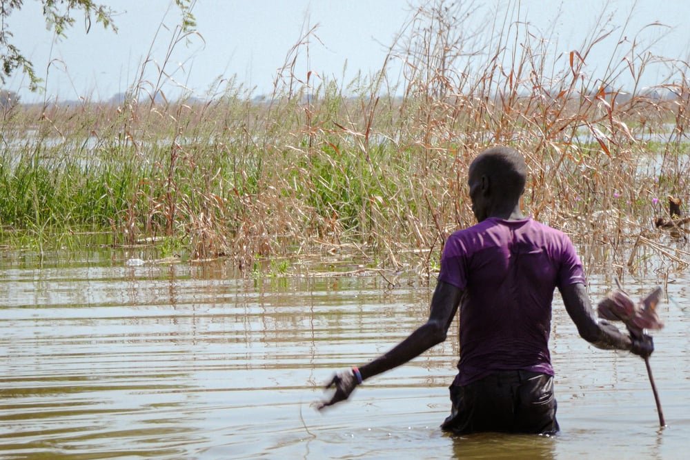 A man wades through floodwaters in Bentiu, Unity state.  