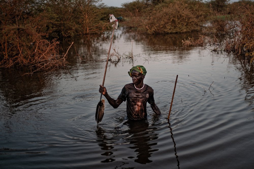 A man wades through floodwaters in Rubkona country in Bentiu while he is fishing. (December, 2021).