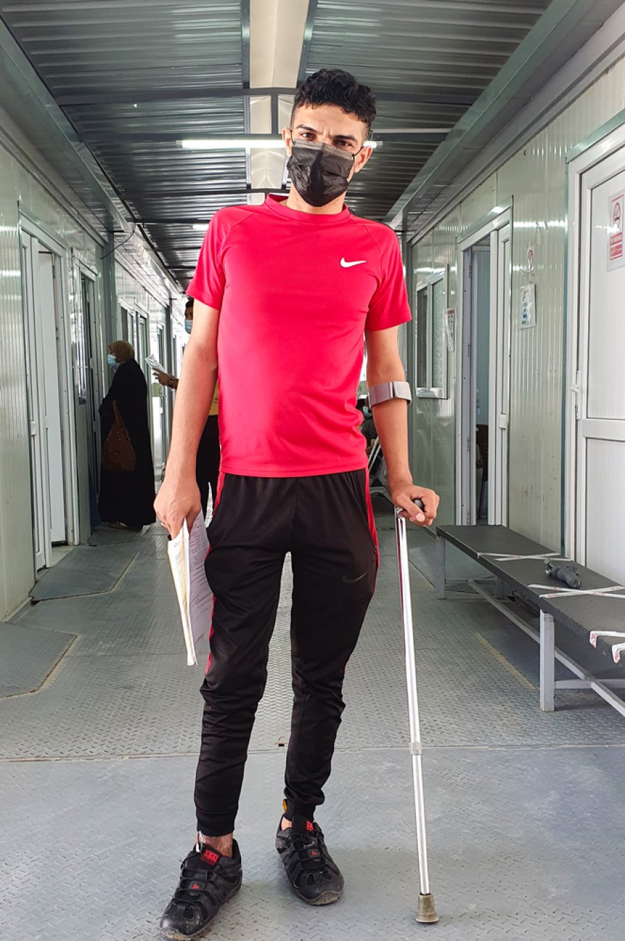 Saqr Badr standing in the outpatient department in al-Wahda hospital in East Mosul after visiting for follow up after being discharged from the facility. 