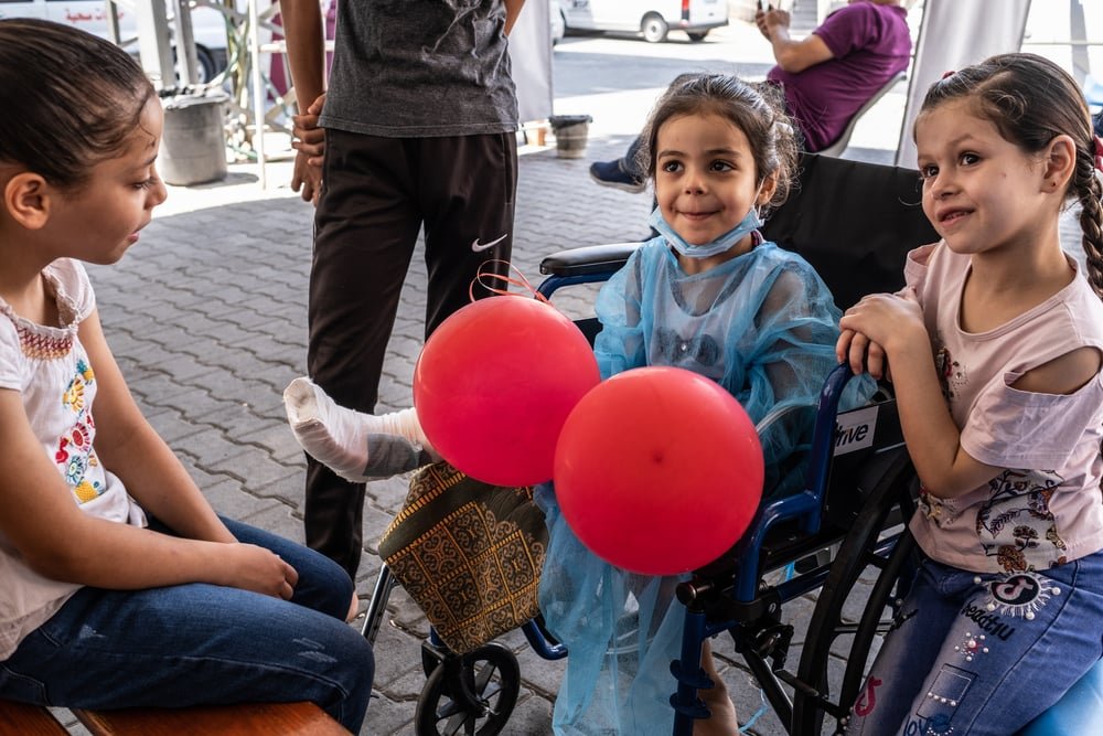 Four-year-old Hala is visited by her sisters and cousin at Al-Awda hospital, a day after surgeons with the MSF limb reconstruction unit operated on her foot.