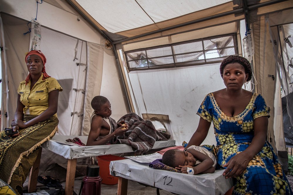Elisabeth Chihemba sits quietly next to her three-year-old son, Elris Kamo, who is suffering from severe dehydration and is barely able to move.