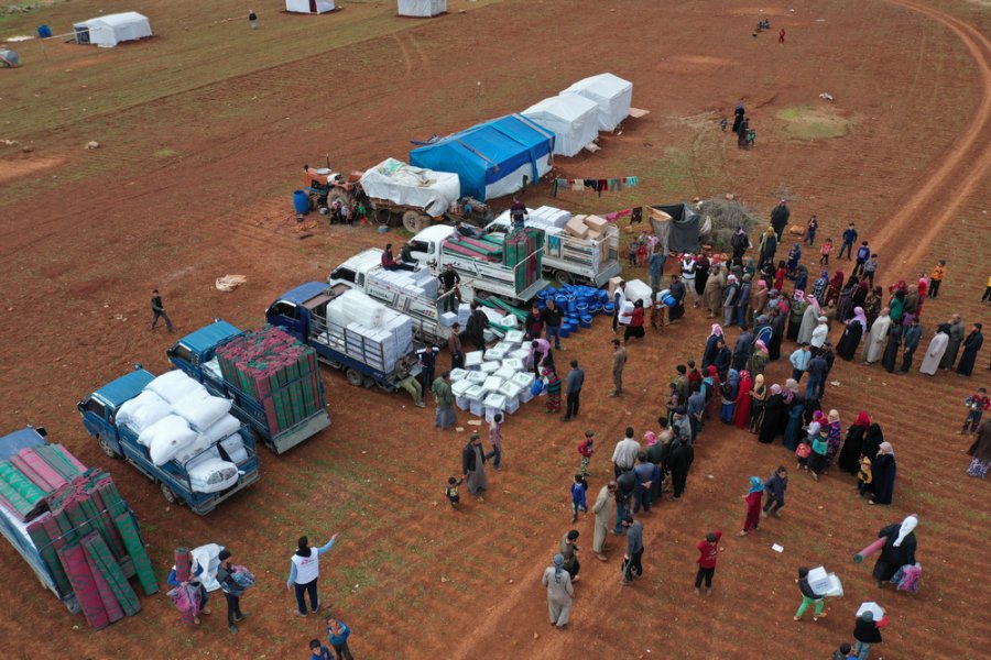 2020: An MSF team distribute essential items, including blankets and hygiene kits, to displaced people in a camp in northwest Syria. Earlier that year, Syrian government forces and their allies launched an offensive on Idlib province. 