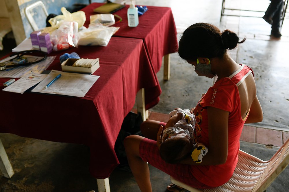 Georgina (19) takes her one-month-old son Isaac for a medical evaluation at the health fair run by MSF, local authorities and the community in Desparramadero, Anzoátegui state, Venezuela.