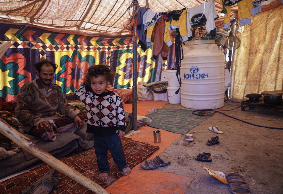 Muhammad lives in Al-Khuseif camp for internally displaced people with his wife and daughter in a small tent that includes an area to sleep and to cook and for a bathroom. (December, 2021).