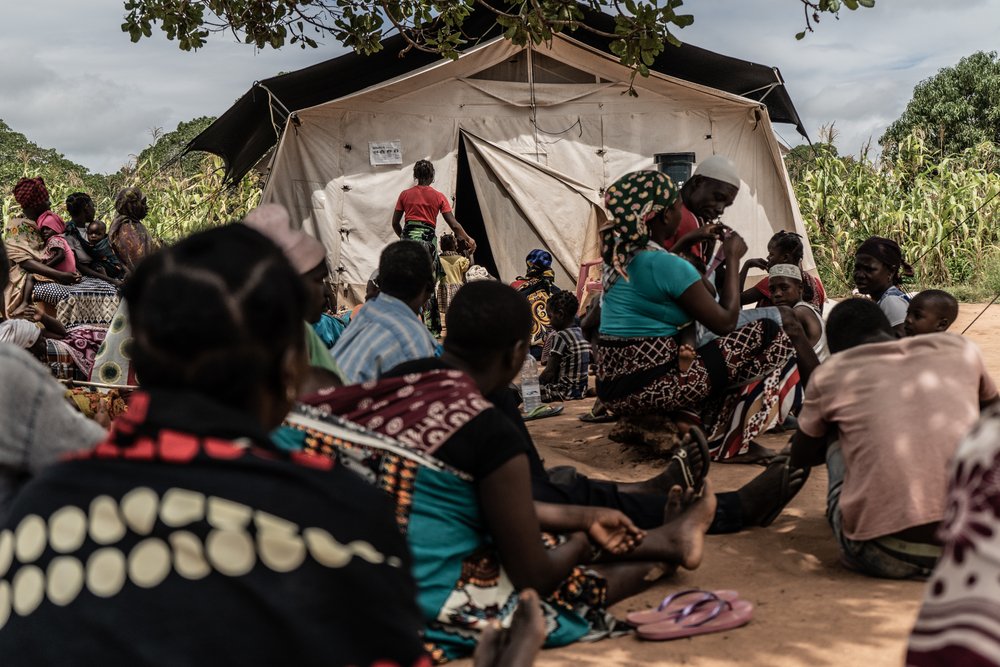 Patients wait in a clearing under a tree to be seen by a medical team providing consultations out of a mobile clinic which MSF is running in the Nicuapa reallocation site for internally displaced people fleeing armed conflict in Cabo Delgado.