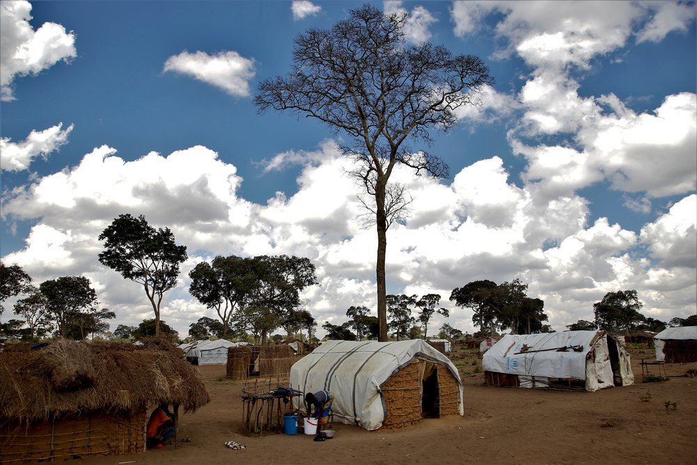 A woman washes clothes next to her tent in Eduardo Mondlane, a resettlement site for displaced people in the town of Mueda. (December, 2021).