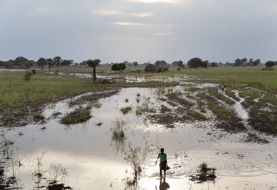 A girl walks through a flooded area on her way home near Aweil Town, South Sudan, October 27th, 2021
