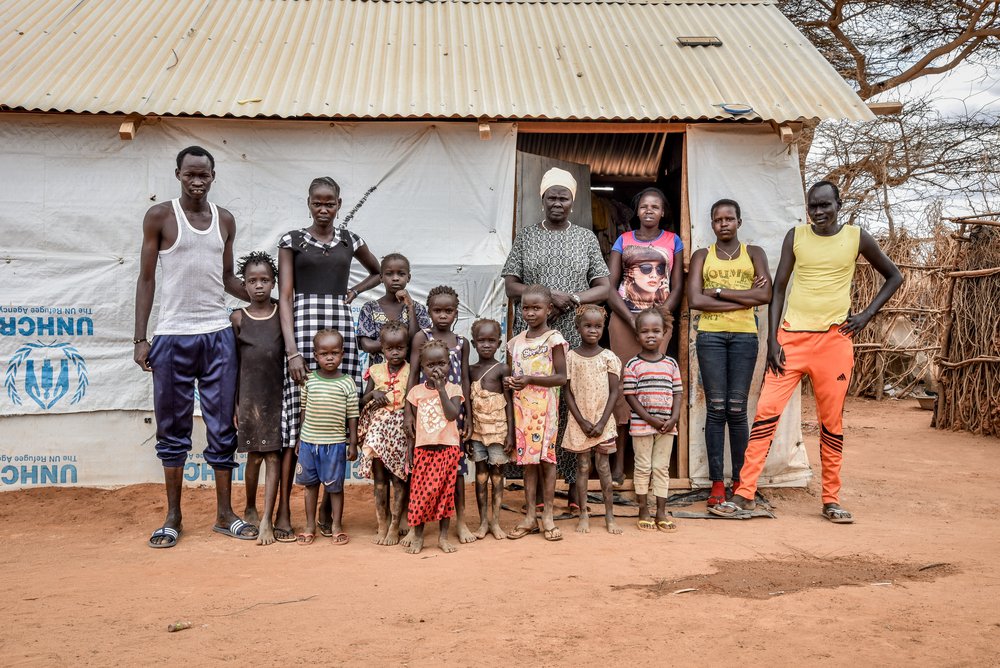 A refugee family standing outside their house in Dagahaley camp.